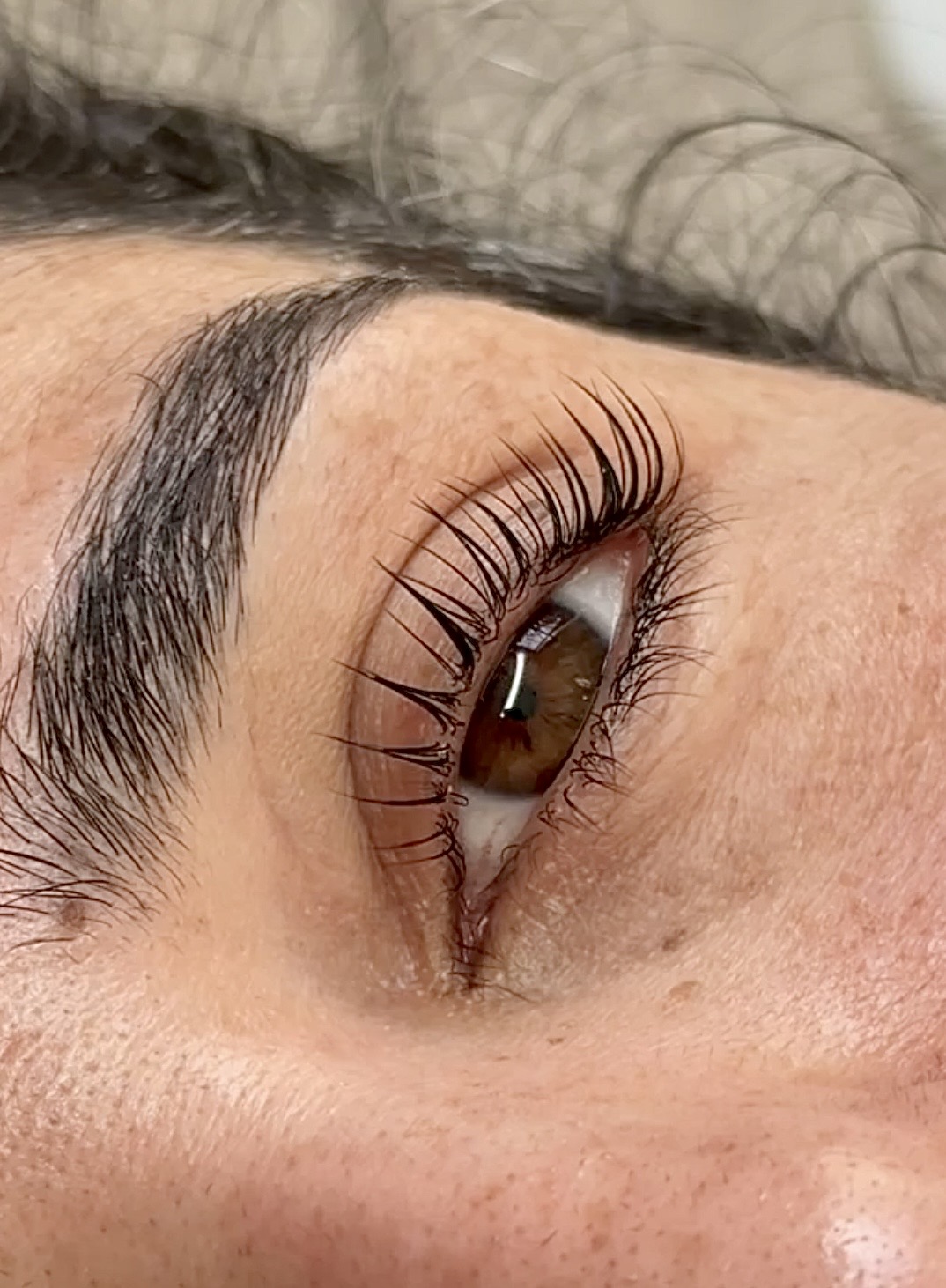 Close-up detail of a lash lift result and natural brow shape